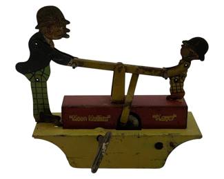 1118 - Moon Mullins & Kayo Tin Litho Wind-up Toy (Description): Vintage tin lithograph wind-up toy featuring Moon Mullins and Kayo characters on a handcar. The toy depicts the two comic strip characters operating a pump-style handcar mechanism, with Moon Mullins in his signature derby hat and plaid pants, and young Kayo in his characteristic bowler hat. The base is painted yellow with a red central platform, and the characters' names are printed on the front. The wind-up mechanism is operated by