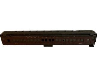 1164 - Ant. Metal Train Car Pennsylvania Railroad (Description): Antique metal train car modeled after a Pennsylvania Railroad passenger coach. This vintage model features a maroon/brown painted finish with gold lettering along the sides, multiple window openings, and detailed roof ventilators. The car shows authentic aging and wear consistent with its age. Measures 5.5" x 30" x 4".