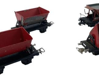 284 - Marklin Dump Cars (4) 2"x2"x4" (Description): These vintage model train cars feature tilting dump bins in red. Each car measures 2" x 2" x 4".