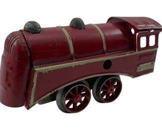 312 - Dayton Hill Climber Locomotive 2"x1"x4" (Description): Dayton Hill Climber locomotive in red painted tin with cream accent striping. This vintage toy train features a streamlined Art Deco design with a rounded front cowl, two black smokestacks, and an open cab with window cutouts. The locomotive rolls on four wheels with red spokes and black rubber tires. Shows wear consistent with age including paint chips and surface oxidation. Measures 2" x 1" x 4".