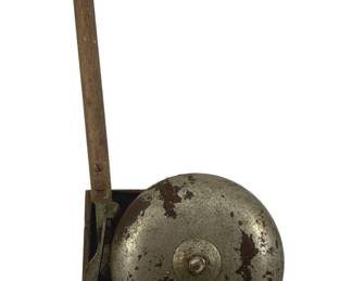 907 - Vintage Hand Ringing Bell 3.5"x4.25"x7" (Description): Antique hand ringing bell featuring a metal dome bell mounted on a wooden backplate with a wooden lever handle. The bell shows an aged patina with areas of wear consistent with use. Measures 3.5"x4.25"x7".