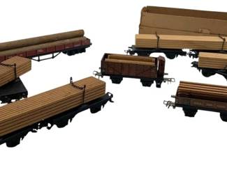 275 - Group Lot of 7 Marklin Lumber & Log Carriers (Description): Group lot of 7 Marklin lumber and log carrier cars. Each car measures 2 inches by 2 inches by 8 inches.