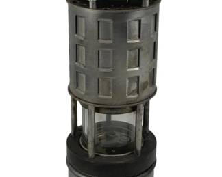 843 - MSHA Kohler Lantern #209 9.5"x3.5" (Description): MSHA Kohler mining safety lantern, model #209. This vintage miner's lamp features a cylindrical metal construction with a protective grid surrounding the upper portion, a glass globe encasing the burner, and a sturdy base. The lantern includes a carrying hook at the top and shows the characteristic design of approved mine safety lamps. Measures 9 1/2" x 3.5". Used as is electric/electronic/mechanical