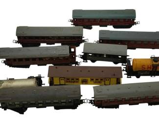 523 - Lot O Scale Trains (Description): A lot of O scale trains including various passenger cars, tank cars, and freight cars. The collection features multiple styles of rolling stock suitable for O gauge model railroad layouts.