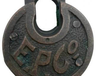 672 - E.P. Co Padlock w/o Key 2.5"x2" (Description): Antique E.P. Co padlock without key. This round cast metal padlock features the embossed letters "E.P. Co" on the front face with decorative rivets. Measures 2 1/2 inches by 2 inches.