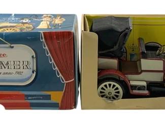 837 - Schuco Old Timer 1902 Mercedes w/ Key & Box (Description): Schuco Old Timer 1902 Mercedes Simplex model car with original wind-up key and box. The vintage tin toy features a red and white color scheme with detailed miniature construction including a folding top, steering wheel, and period-appropriate styling. Comes in the original decorative Schuco Oldtimer box with theatrical curtain design.