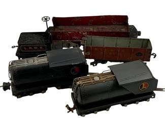 1001 - 5pc Set Lionel Tin Litho Trains 4"x9"x3" (Description): A five-piece set of Lionel tin lithograph trains. The collection includes various freight cars and locomotives featuring the classic Lionel markings. Measurements are 4 inches by 9 inches by 3 inches.