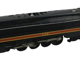 874 - Lionel #746 Locomotive 3.5"x13"x2.5" (Description): Lionel #746 locomotive model train in classic black with red and yellow striping. This streamlined steam locomotive features the number 746 displayed on the side, silver accents, and detailed wheel assembly. Measures 3.5 inches high by 13 inches long by 2.5 inches wide.