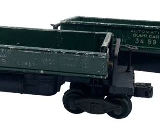213 - Lionel Dumpster Cars 2"x2"x10" (Description): Lionel dumpster cars measuring 2 inches by 2 inches by 10 inches.