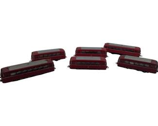 314 - Group Lot of 6 Marklin Passenger Cars (Description): Group lot of six Marklin passenger cars in classic burgundy red livery with silver/gray roof details. These HO scale model train cars feature detailed windows and coupling hooks for connecting to other rolling stock. Each car measures 2 inches by 2inches by 6 inches.