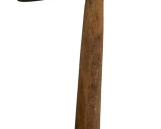 103 - Antique Wooden Marde Axe 9"x6" (Description): Antique wooden Marde axe featuring a forged iron head with a flared cutting edge and tapered poll. The weathered wooden handle shows age-appropriate wear and includes a drilled hole near the base, likely for hanging storage. The iron head displays a rich patina consistent with age and use. Measures 9 inches by 6 inches.