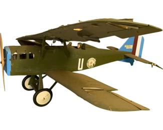 1132 - Gas Powered Model Biplane 19"x43"x54" (Description): Gas powered model biplane in military olive green finish with blue and red French-style tricolor markings on the tail. The aircraft features a two-wing biplane configuration with a wooden propeller, dual rubber landing wheels, and a cockpit with pilot figure. The fuselage displays a white "U" marking and circular insignia on the side. Measures 19" x 43" x 54".