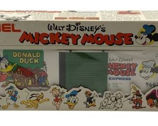 833 - Lionel Donald Duck Box Car O Scale in Box (Description): Lionel Donald Duck Box Car in O Scale, complete with original box. This Walt Disney's Mickey Mouse Express train car features Donald Duck themed artwork on the sides. The car is part of the 1977 Walt Disney Productions licensed Lionel train series. Includes the original illustrated box featuring various Disney characters along the bottom edge.