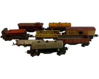 1171 - Lot O Scale Trains 3"x8.5"x2" (Description): A lot of O scale model trains featuring various freight cars. The collection includes branded tank cars marked Shell and Sunoco (S.U.N.X. 2680), a Baby Ruth boxcar, a Lionel gondola car, hopper cars, and a caboose. The vintage tinplate cars show play wear consistent with age. Each car measures approximately 3 inches by 8.5 inches by 2 inches.