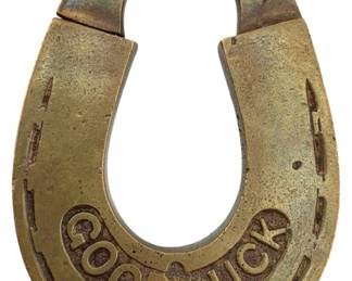 668 - Good Luck Pat. 1879 Padlock w/o Key 3"x2" (Description): Antique brass horseshoe-shaped padlock embossed with "Good Luck" and patented June 24, 1879. This novelty lock features a decorative horseshoe design with simulated nail holes. Key is not included. Measures 3" x 2".