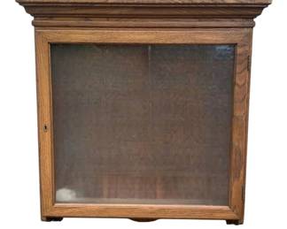 417 - Wooden Hanging Display Case w/ Shelves (Description): A wooden hanging display case featuring a glass front door with lock and interior shelving. The case has a handsome crown molding top and traditional styling, making it suitable for displaying collectibles or other treasured items. Measures 34 inches by 32 inches by 7 inches.