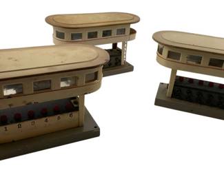 348 - Group of 3 Marklin Germany Train Towers (Description): Group of three Marklin Germany model train switch towers. Each tower features a cream-colored body with red trim, windowed upper sections, and a control panel with numbered red buttons. Measures 6 inches by 6 inches by 6 inches.