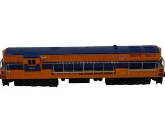 918 - Lionel #2341 Locomotive O Scale 4"x16"x3" (Description): Lionel #2341 Locomotive in O Scale, featuring the classic Jersey Central Lines livery in orange and blue. This diesel locomotive model displays the road number 2341 and includes detailed railings and ventilation grilles. Measures 4 inches high by 16 inches long by 3 inches wide.