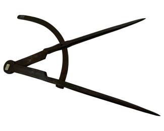 701 - Antique Hand Forged Divider 14.5"x7" (Description): Antique hand forged divider measuring 14 1/2 inches by 7 inches. This iron tool features the characteristic patina and craftsmanship of hand-forged metalwork, with curved caliper arms and pointed legs for marking and measuring.