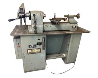 788 - Hardinge Precision Lathe DV59 55"x56"x30" (Description): Hardinge Precision Lathe, model DV59. This industrial-grade lathe is manufactured by Hardinge Brothers Inc. of Elmira, NY, USA. The lathe features a headstock with multiple speed settings, tailstock, and carriage assembly mounted on a sturdy steel cabinet base with integrated storage compartment. Measures 55" x 56" x 30". Used as is electric/electronic/mechanical item. No guarantee all components, untested.