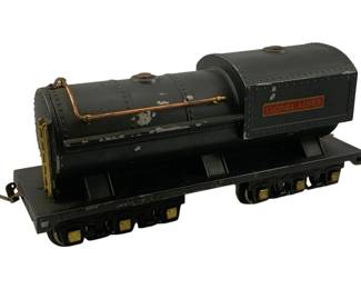 921 - Lionel Lines Oversized Metal Locomotive Toy (Description): Lionel Lines oversized metal locomotive toy in black finish with painted copper and brass-colored accents. This substantial train piece features the classic 'Lionel Lines' nameplate in red and gold on the boiler. The locomotive shows authentic vintage wear with paint loss and patina consistent with age and play use. Mounted on an eight-wheel chassis with yellow-painted wheel details. Measures 5.5"x12"x4".