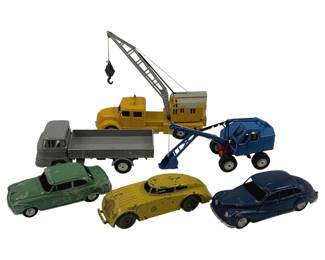 868 - 6pc Lot Matchbox & Misc Die-Cast Vehicles (Description): Collection of six vintage die-cast toy vehicles including Matchbox and miscellaneous makers. The lot features a variety of vehicle types including a yellow crane truck, gray flatbed truck, blue excavator, and three passenger cars in green, yellow, and blue. The toys show age-appropriate play wear with paint loss consistent with well-loved vintage pieces. Measures approximately 3 inches.