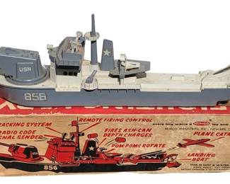 534 - Remco Fighting Lady Battleship w/ Box (Description): Remco Fighting Lady Battleship with original box. This vintage toy battleship features gun tracking system, remote firing control, radio code signal sender, depth charges, rotating pom-poms, plane catapults, and landing boat capabilities. Measures 33 inches long by 5 inches wide by 7 inches tall.