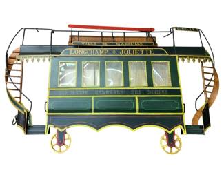 764 - Cable Car Wall Art Metal 16"x28" (Description): Metal wall art depicting a cable car. This decorative piece features a vintage French omnibus design with detailed railings, ladders, and wheels. Measures 16 inches by 28 inches.