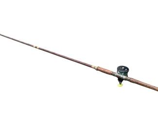404 - Penn Reel w/ Fishing Pole 101" (Description): Penn reel with fishing pole. Measures 101 inches in length.