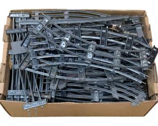 991 - Box Lot O-Scale Train Tracks (Description): A box lot of O-scale train tracks. The lot includes an assortment of track sections suitable for model railroad layouts.