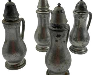 130 - Group of 4 Pewter Salt & Pepper Shakers 4.5" (Description): Group of four pewter salt and pepper shakers in a classic baluster form with footed bases. Two shakers feature elegant curved handles while two are handleless. Each shaker is topped with a domed pierced lid and decorative finial. The pewter displays a rich aged patina consistent with vintage pieces. Measures 4.5 inches tall.