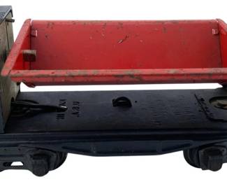 291 - Lionel Dump Car 3"x3"x8" (Description): Featuring a tilting red dump bed mounted on a black flatcar base. Measures 3 inches by 3 inches by 8 inches.