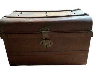 170 - Vtg Metal Trunk w/ Brass Hardware 16"x23"x16" (Description): Vintage metal trunk featuring a dome-top lid with decorative banding and brass studs. The trunk is fitted with ornate brass hardware including a hasp closure and keyhole lock plate. The body displays a rich brown patina and sturdy construction with reinforced corners. Measures 16 inches high by 23 inches wide by 16 inches deep.