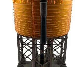 267 - Lionel Lines Water Tower No. 30 11"x8" (Description): Lionel Lines water tower no. 30. This model railroad accessory features a golden ribbed tank marked "Lionel Lines" mounted on a dark brown structural framework with a central spout. Measures 11" x 8".