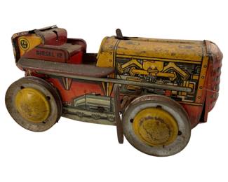 709 - Vintage Marx Tin Wind-up Tractor 5"x9"x6" (Description): Vintage Marx tin wind-up tractor featuring colorful lithographed decoration. This classic toy measures 5 inches wide by 9 inches long by 6 inches tall.