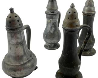 131 - Group of 4 Pewter Salt & Pepper Shakers (Description): Group of 24 pewter salt and pepper shakers measuring 4.5 inches. The collection includes various styles including footed pitcher-form shakers with curved handles and traditional baluster-shaped shakers with pedestal bases. All feature perforated domed tops with decorative finials. The pewter displays an aged patina consistent with antique pieces.