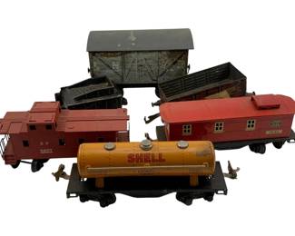 959 - 6pc. Lot Vtg Train Cars 3.5"x7"x2" (Description): A collection of six vintage train cars including various styles such as a caboose, boxcar, cattle car, gondola, baggage car, and a Shell petroleum tanker car. The lot features models marked with different railroad designations. Each car measures approximately 3 1/2 inches by 7 inches by 2 inches.