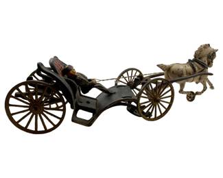 5 - Antique Cast Iron Horse & Carriage Toy (Description): Antique cast iron horse and carriage toy featuring a painted white horse pulling a black carriage with a seated driver. The carriage has spoke wheels and the driver figure sits in a red-backed seat holding reins. The horse piece has damage where it hooks to the carriage. Measurements: 4.25" x 7" x 4" and 5" x 9" x 3.25".