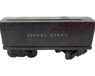114 - Vtg Lionel O-Gauge Sheet Metal Tender Car (Description): Vintage Lionel O-Gauge sheet metal tender car marked "Lionel Lines" on the side. This black painted tender features a riveted design and rides on two four-wheel trucks. Shows wear consistent with age and use. Measures 2.5" x 6" x 2.25".
