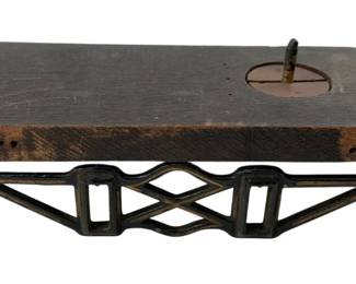794 - Train Decor 3"x10"x3" (Description): Decorative train piece featuring a wooden top platform with metal base. The base has an ornate openwork design with geometric patterns and decorative fan-shaped feet. Measures 3 inches tall by 10 inches long by 3 inches deep.