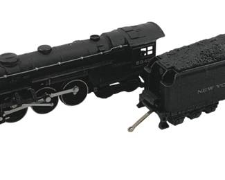 910 - Lionel #5342 Locomotive w/ Coal Car HO Scale (Description): Lionel #5342 locomotive with coal car in HO scale. This black steam locomotive features detailed construction with visible wheel mechanisms and connecting rods. The accompanying tender car is marked "New York Central" and features a realistic coal load. Measures 2.5" x 9" x 1.5".