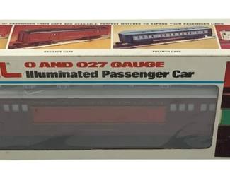 849 - Lionel Armstrong Baggage Car O Scale in Box (Description): Lionel Armstrong Baggage Car in O Scale, complete with original box. This illuminated passenger car is designed for O and 027 gauge layouts. The car features a classic red and silver color scheme. Comes in the original Lionel packaging showing various passenger train car configurations.