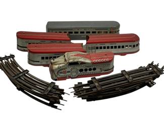 999 - 5pc Set Marx Metal Trains & Tracks (Description): Five-piece set of Marx metal trains and tracks. The collection includes multiple train cars and sections of track. Measures 5 x 8 x 0.5 inches.