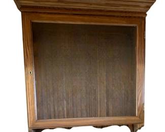 466 - Hanging Wood Wall Cabinet w/ Glass Shelves (Description): Hanging wood wall cabinet with glass shelves. Features a glass-front door with keyhole hardware and decorative crown molding at the top. Measures 34 inches wide by 32 inches tall by 7 inches deep.