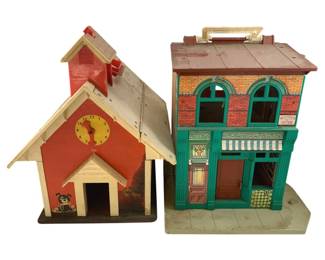 509 - 2pc. Fisher-Price Playsets 13"x12"x10" (Description): Two Fisher-Price playsets including a schoolhouse with clock tower and bell and a Sesame Street-style building featuring Hooper's Store. Measures 13"x12"x10".