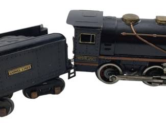 344 - Lionel Lines No 258 Locomotive & Coal Car (Description): Lionel Lines No 258 locomotive and coal car set. The locomotive features brass detailing and copper piping, paired with a matching Lionel Lines tender. Measures 4" x 8" x 2.5".