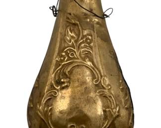 974 - Brass Powder Horn 6.5"x3.5"x1.5" (Description): Brass powder horn featuring embossed decorative scrollwork and floral designs. The flask has a screw-top cap and wire hanging loops. Measures 6.5" x 3.5" x 1.5".