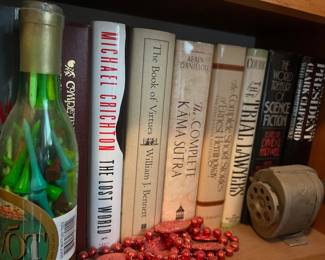 Jim, Complete Works of William Shakespeare, The Lost World, The Book of Virtues, The Complete Kāma Sūtra, The Complete Short Stories of Ernest Hemingway, The Trial Lawyers, The World Treasury of Science Fiction, Presidency, Clark Clifford, bottle with golf tees, electric pencil sharpener, red bead garland.