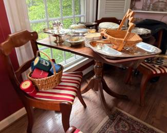 Dining table of silver serveware and baskets