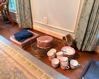 Pink china teacups, saucers and vintage hat boxes